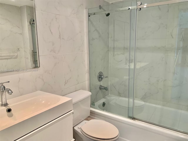 1500 S Ocean Dr Unit 17E, Hollywood, FL 33019 - full bath with bath / shower combo with glass door, toilet, tile walls, and vanity