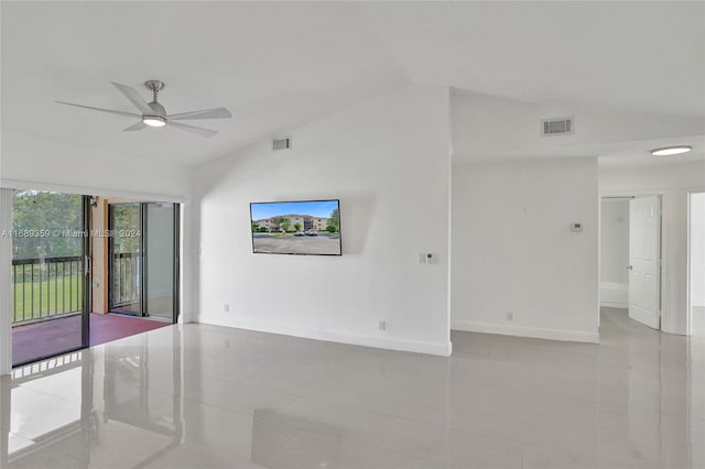 spare room featuring light tile patterned floors, vaulted ceiling, and ceiling fan