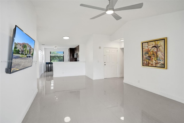 interior space with lofted ceiling and light tile patterned flooring