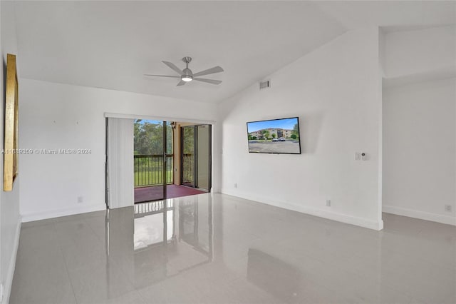 tiled empty room with ceiling fan and lofted ceiling