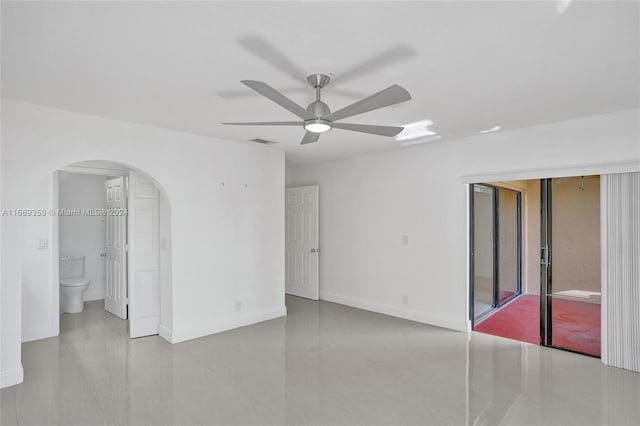 interior space with ceiling fan and ensuite bathroom