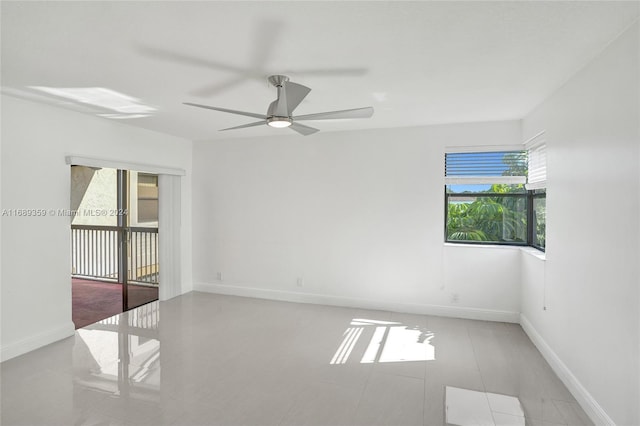 spare room featuring ceiling fan and light tile patterned flooring