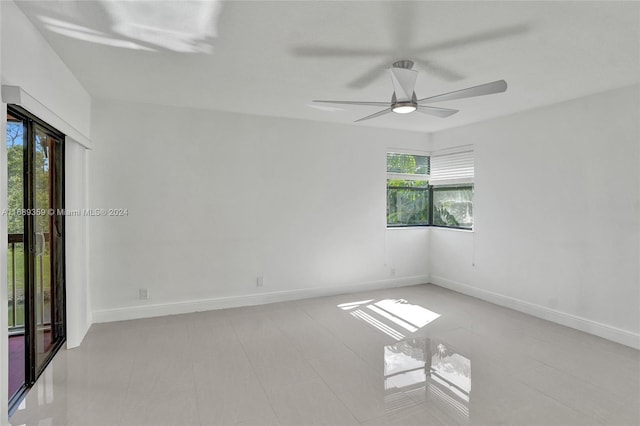 unfurnished room featuring ceiling fan and light tile patterned floors