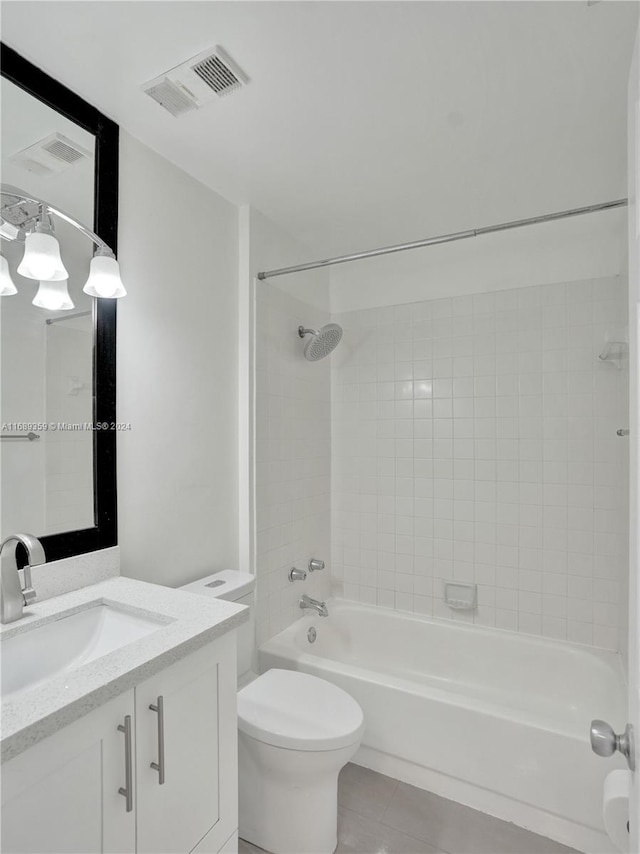 full bathroom with toilet, vanity, tile patterned floors, and tiled shower / bath