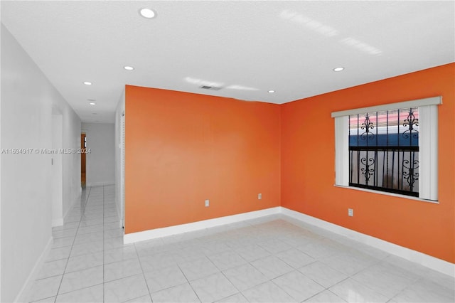 unfurnished room featuring a textured ceiling