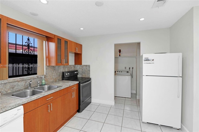 kitchen with sink, washer / clothes dryer, white appliances, decorative backsplash, and light tile patterned floors