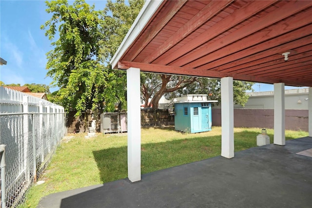 view of patio featuring a storage unit