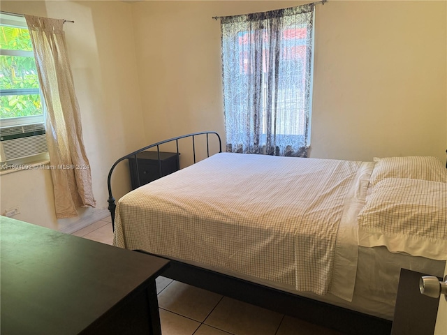 bedroom featuring light tile patterned floors and cooling unit