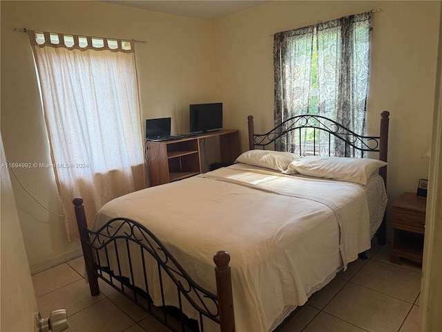 bedroom featuring light tile patterned flooring