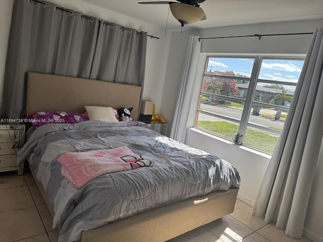 bedroom with ceiling fan and light tile patterned flooring