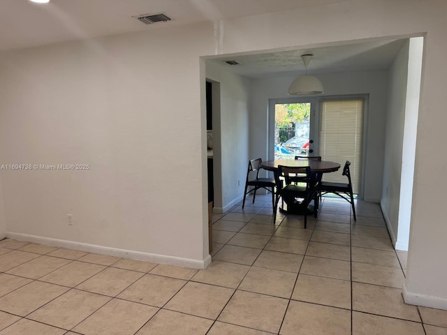 dining space featuring light tile patterned flooring