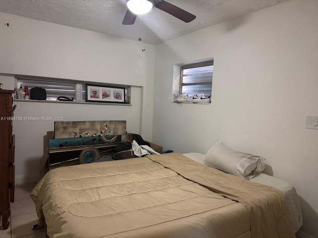 bedroom with a textured ceiling and ceiling fan