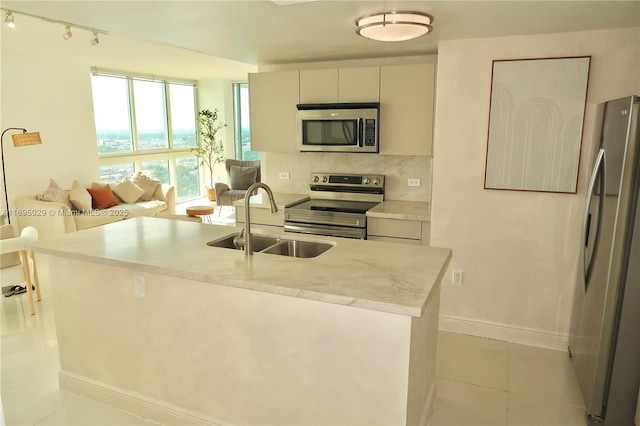 1861 NW S River Dr Unit 2505, Miami, FL 33125 - kitchen featuring light countertops, a sink, baseboards, tasteful backsplash, and appliances with stainless steel finishes