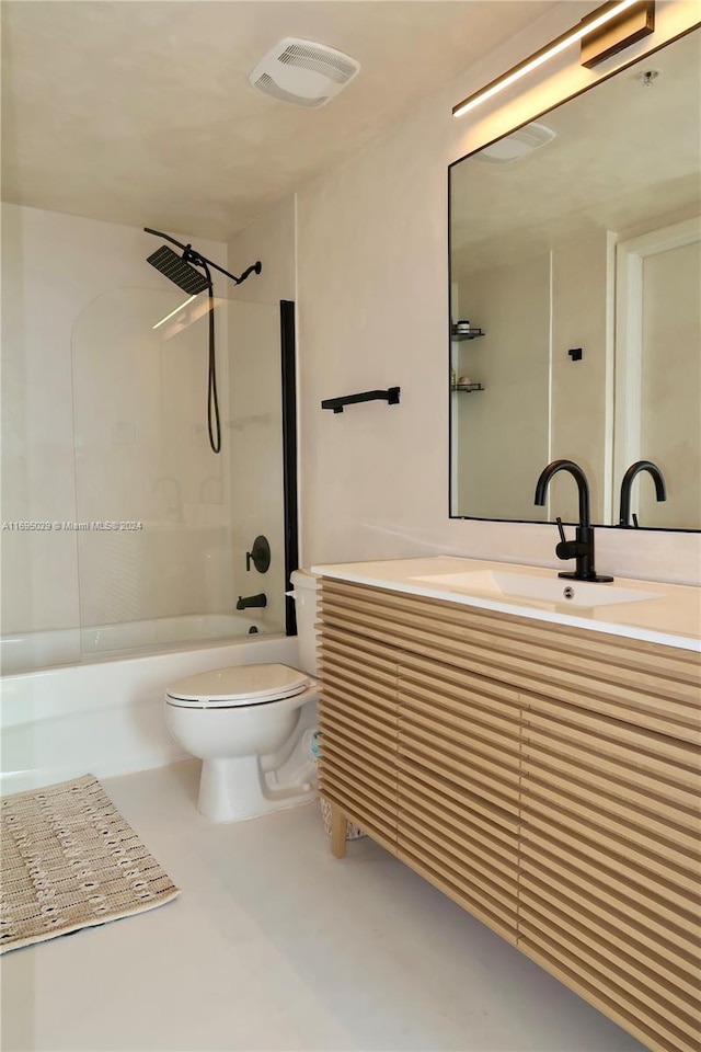 full bathroom featuring vanity, tiled shower / bath combo, and toilet