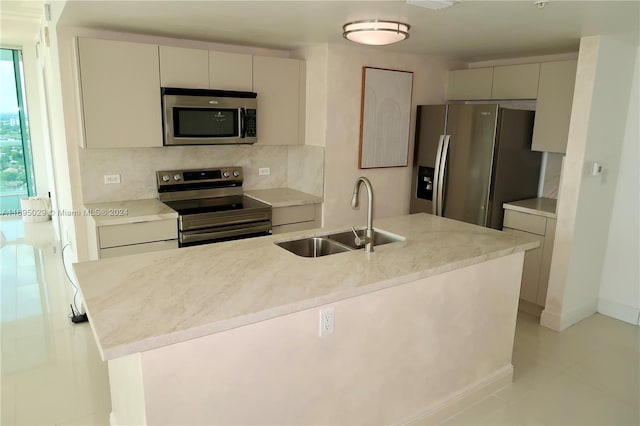 kitchen featuring backsplash, light tile patterned flooring, sink, and stainless steel appliances