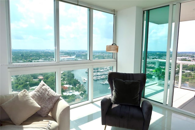 living area with a wealth of natural light and a water view