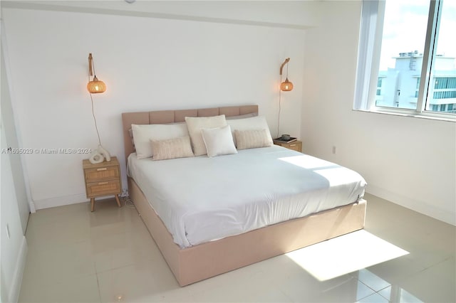 bedroom with light tile patterned floors