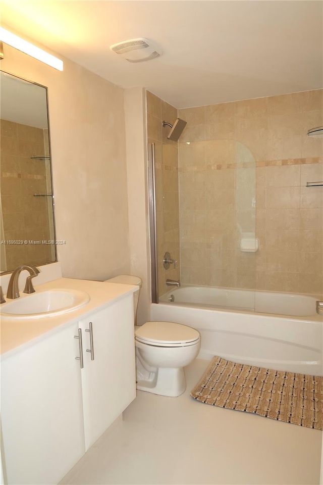 full bathroom featuring vanity, toilet, and tiled shower / bath combo