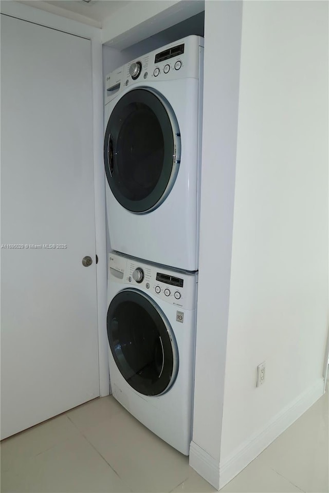 1861 NW S River Dr Unit 2505, Miami, FL 33125 - laundry room featuring stacked washing maching and dryer, laundry area, and light tile patterned floors