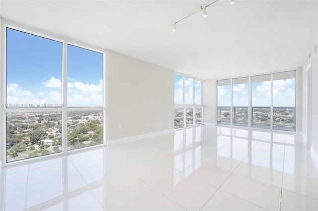 1861 NW S River Dr Unit 2505, Miami, FL 33125 - empty room featuring a wall of windows, baseboards, and light tile patterned floors