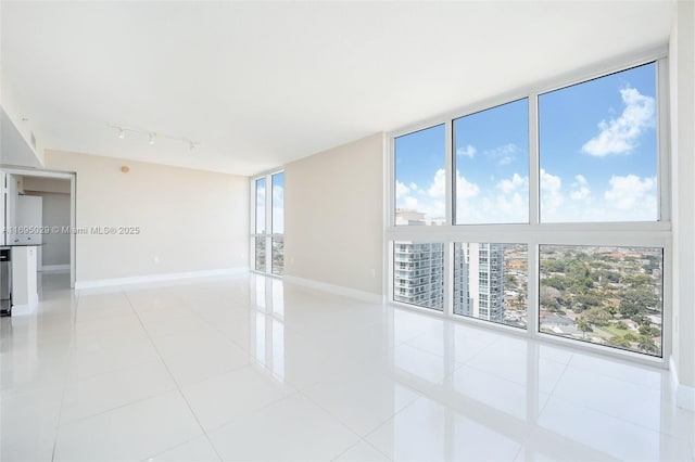 1861 NW S River Dr Unit 2505, Miami, FL 33125 - spare room with baseboards, rail lighting, and light tile patterned floors