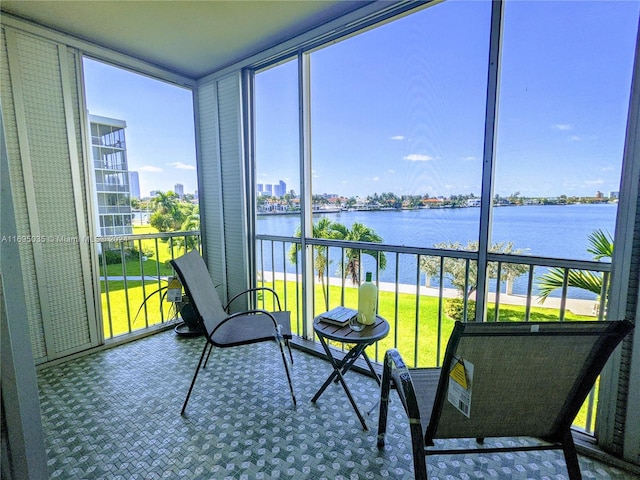 sunroom / solarium featuring a water view