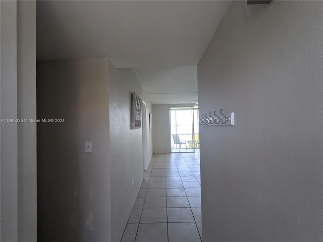 hall featuring light tile patterned flooring