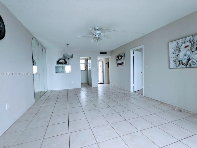 spare room featuring ceiling fan and light tile patterned floors