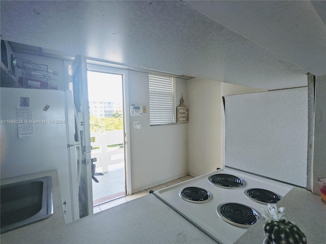 kitchen featuring white appliances and sink