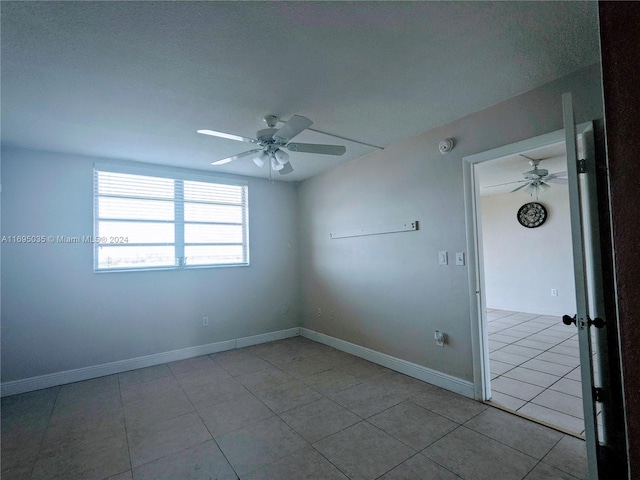 tiled empty room with ceiling fan