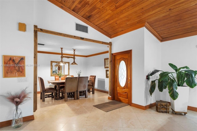 entrance foyer with wood ceiling, vaulted ceiling, and ornamental molding