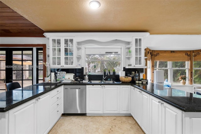 kitchen featuring kitchen peninsula, dishwasher, and white cabinets