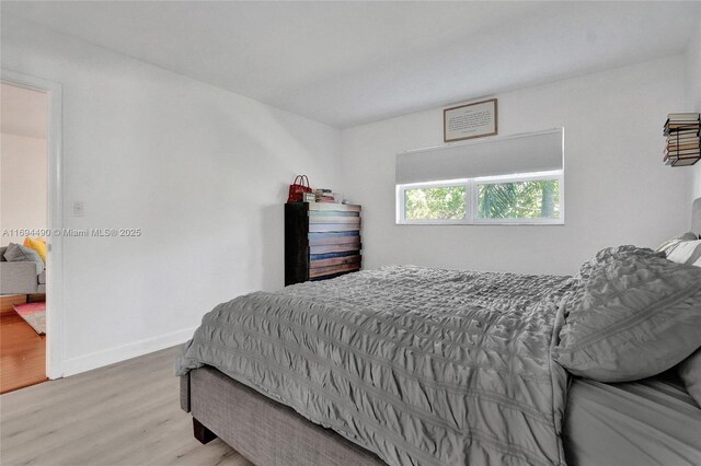 bedroom with hardwood / wood-style floors