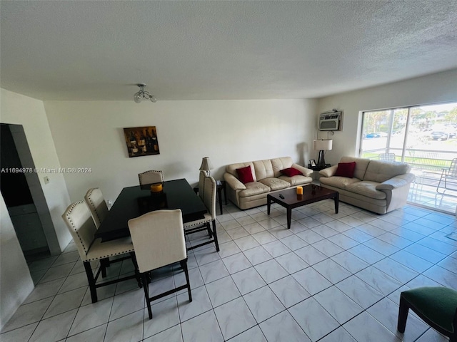 living room featuring a textured ceiling, light tile patterned floors, and a wall mounted air conditioner