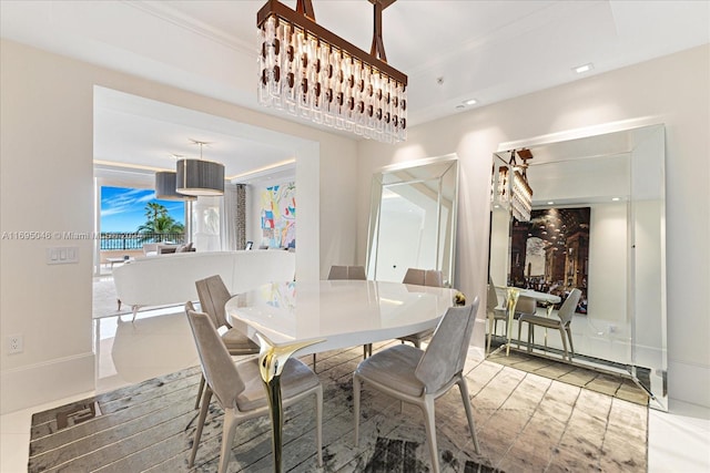 dining space featuring crown molding