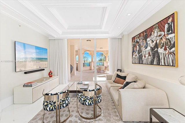 living room with a tray ceiling and ornamental molding