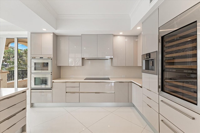 kitchen with gray cabinets, light tile patterned flooring, ornamental molding, and wine cooler