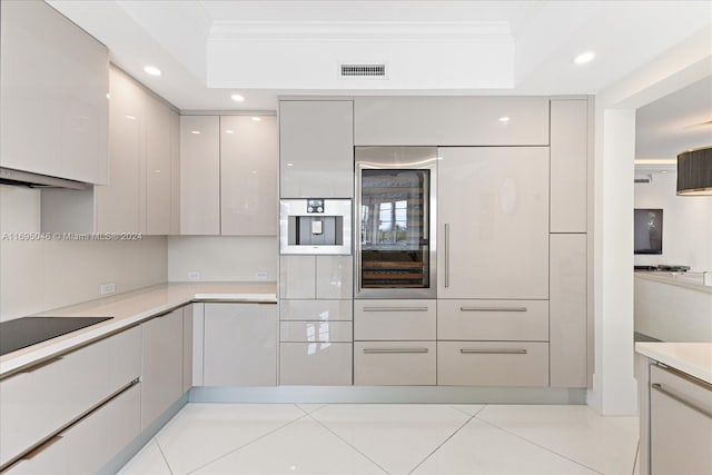 kitchen featuring gray cabinetry, exhaust hood, black electric cooktop, ornamental molding, and light tile patterned flooring