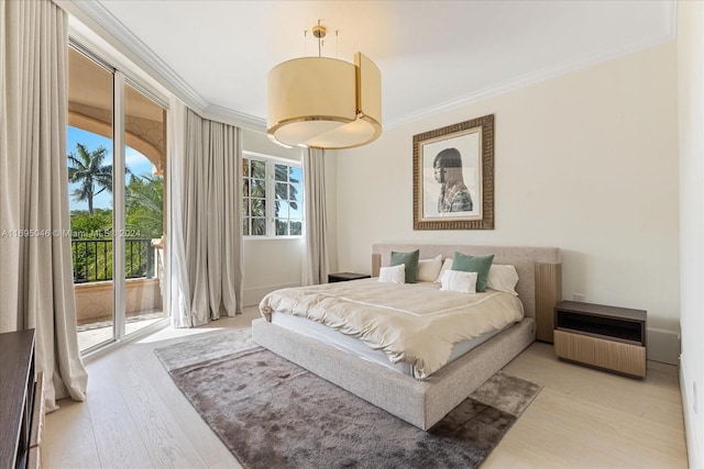 bedroom featuring access to exterior, crown molding, and light hardwood / wood-style flooring