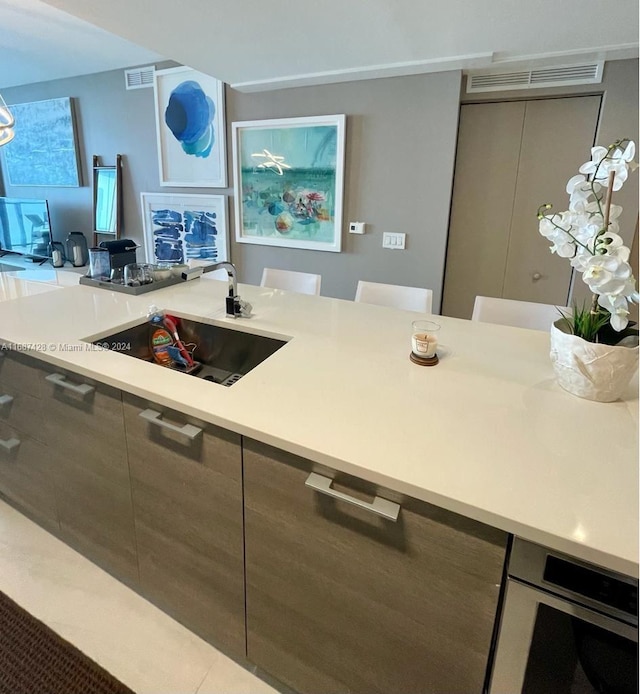 kitchen featuring sink and light tile patterned floors