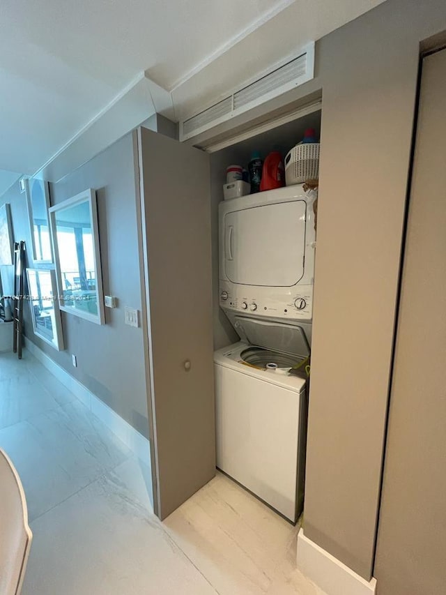 washroom featuring stacked washer and dryer