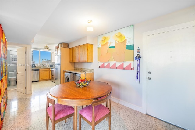 524 Orton Ave Unit 603, Fort Lauderdale, FL 33304 - dining room featuring baseboards, light speckled floor, and washer / clothes dryer