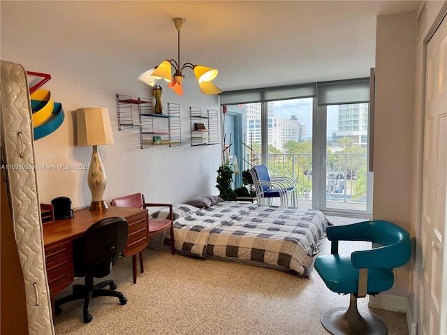 bedroom featuring expansive windows and a notable chandelier