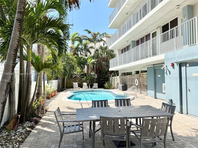 524 Orton Ave Unit 603, Fort Lauderdale, FL 33304 - view of pool featuring a fenced backyard, outdoor dining space, a patio area, and a fenced in pool