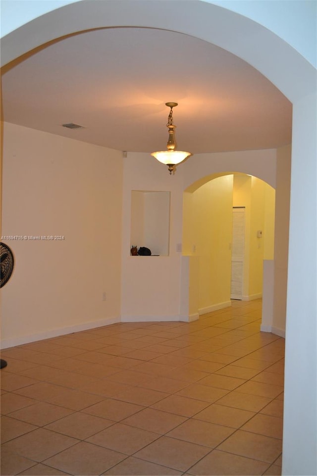 unfurnished room featuring tile patterned flooring