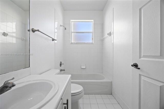 bathroom with toilet, vanity, tile patterned floors, and shower / washtub combination