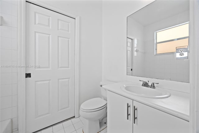 bathroom with toilet, vanity, tile patterned floors, and walk in shower