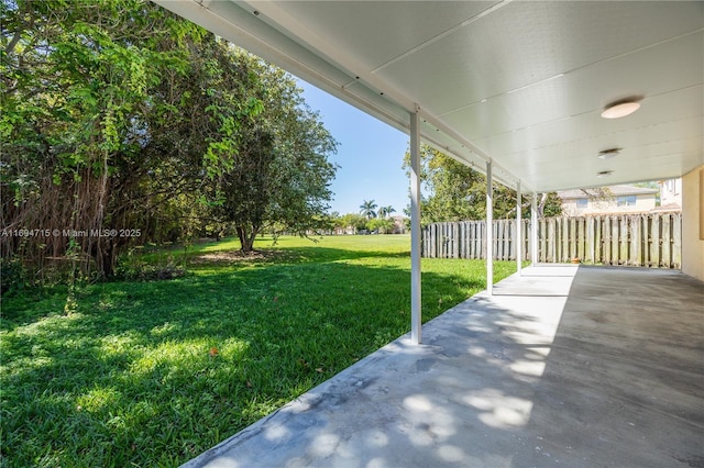 view of yard featuring fence and a patio area
