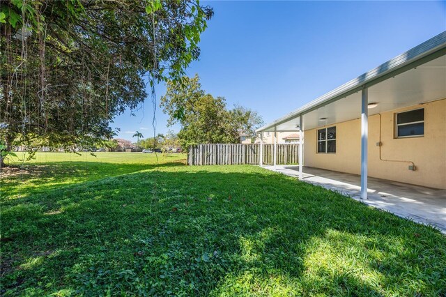 view of yard featuring a patio area and fence