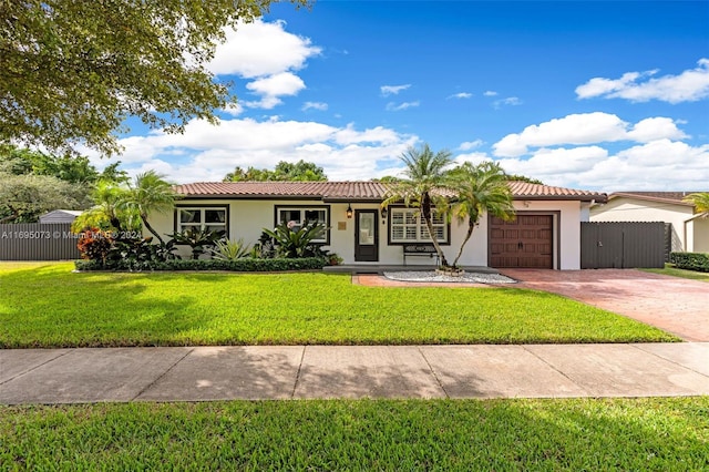 ranch-style home with a front yard and a garage